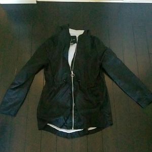 A black raincoat that is made from Me Jane